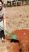 Woman shovels sand